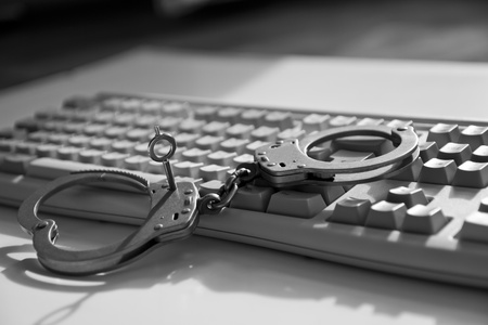 Handcuffs on keyboardの写真素材