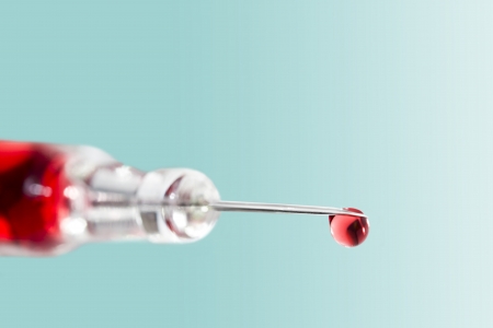 Syringe vial with liquid dropの写真素材