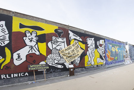 BERLIN - MARCH 06: The East Side Gallery is the largest outdoor art gallery in the world and under the current worldwide  protest in terms of the removal of several  Berlin Wall segments  to allow the construction of a luxury hotel in  MARCH 06, 2013 in Bのeditorial素材