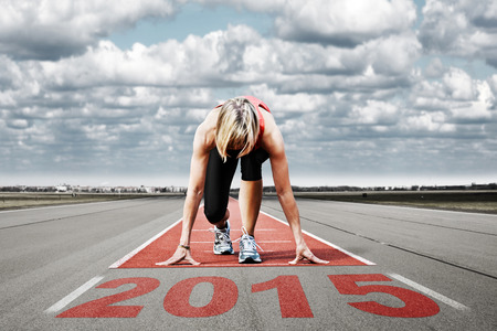 Female sprinter waiting for the start on an airport runway In the foreground perspective view of the  date 2015 の写真素材