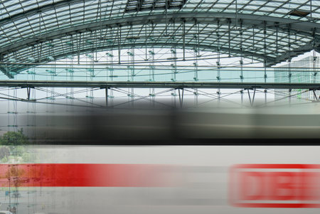 BERLIN, GERMANY- AUGUST 10, 2013: Passing ICE train with brand of the Deutsche Bahn at the main train station of Berlin, Hauptbahnhofのeditorial素材