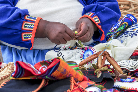 Uru woman from lake Titicaca Creates traditional artwork of the Uru peopleの写真素材