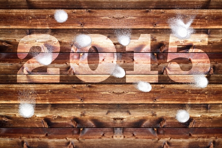 Wooden board with bleached out 2,015 letters, Which is bombarded with snowballs.の写真素材