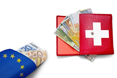 Swiss franc and euro wallets with national colors banners overlayの写真素材