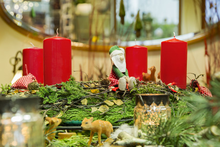 Advent wreath ensemble with with four red candles,cute forest scene and handmade cloth Santa Claus.の写真素材