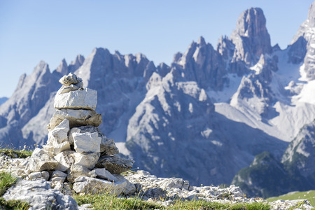 Stacked rough rocks with the typical mountains of the dolomites in the backgroundの写真素材