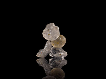 Carefully balanced sharp sand grains on black background. High resolution image