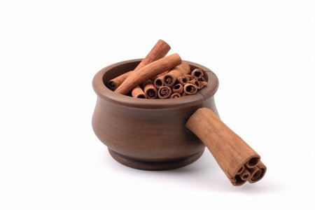 Cinnamon sticks in a clay pot on a white background, isolateの素材