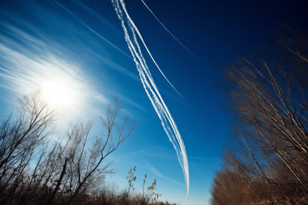 Traces of an airplane in the blue sky. Blue sky background.の素材