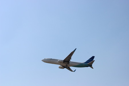 Garuda Indonesia Boeing 737-8U3NG (PK-GMZ) taking off from Adi Sumarmo International Airport, Solo, Indonesiaのeditorial素材