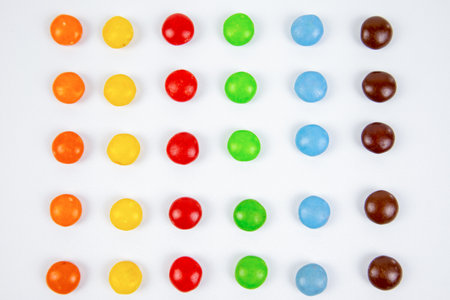 Colorful candies on white background. Top view. Flat lay.