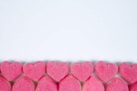 Pink heart shaped marshmallows on white background with copy space.の写真素材