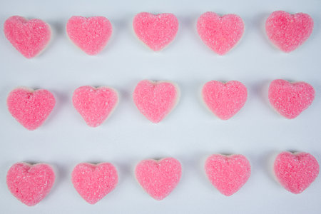 Pink heart shaped jelly candies on white background. Top view.