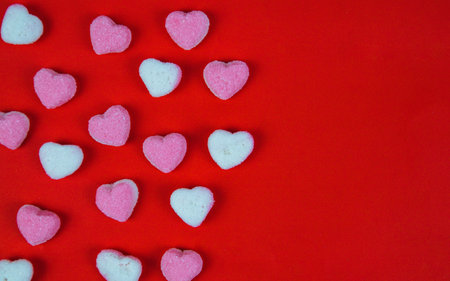 Valentine's day background with pink and white hearts on red backgroundの写真素材