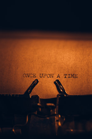 ONCE UPON A TIME typed words on a vintage typewriter. Close up. Antique Typewriter.