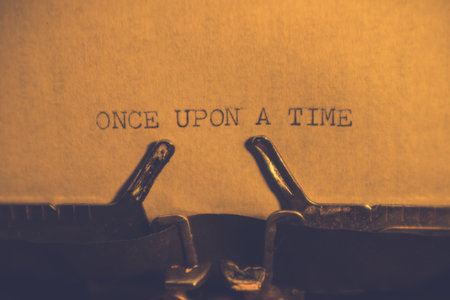 ONCE UPON A TIME typed words on a vintage typewriter. Close up. Antique Typewriter.