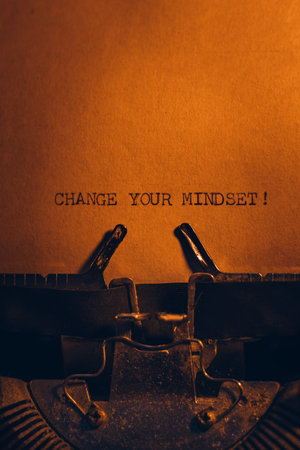 CHANGE YOUR MINDSET! typed words on a vintage typewriter. Close up. Antique Typewriter.