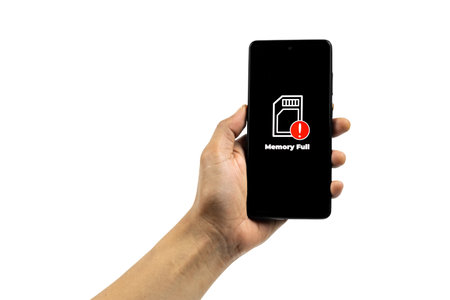 Cellular Problems Concepts. Man hand holding smart phone with full storage icon on screen isolated...