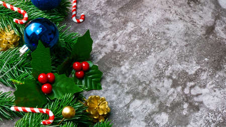 Christmas pine tree leaves and christmas decorations on grunge background. Creative christmas concept.の写真素材