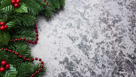 Christmas decorations, pine tree leaves, balls, berries on grunge background, Selective focus christmas conceptの写真素材