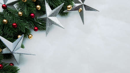 Christmas decorations, pine tree leaves, balls, berries on snow white background, Christmas conceptの写真素材
