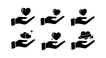 Vector set shows black hand silhouettes holding hearts in various positions symbolizing love, care, and support. Clean style with clear shapes and simple design, modern and minimalistic mood.のイラスト素材