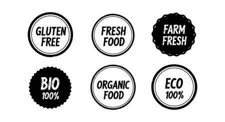 Set of six black and white circular badges with gluten free, fresh food, farm fresh, bio, organic food, and eco 100% text for natural product packaging, clean design, minimalist style. Calm.のイラスト素材