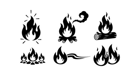 Vector collection of black fire flame icons including campfire, bonfire, and burning log designs presented on a white background, ideal for creative and graphic design uses, dynamic and bold.のイラスト素材