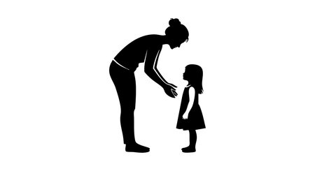 Silhouette of a mother bending forward and talking to her daughter standing in front of her in a simple black vector illustration conveying care and communication moodのイラスト素材