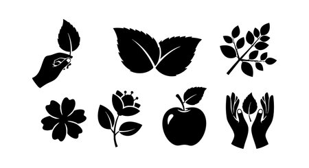 Black silhouette icons include hand holding leaf, two leaves, branch with berries, flower, rose, apple, and two hands protecting leaf in vector style. Calm mood.のイラスト素材