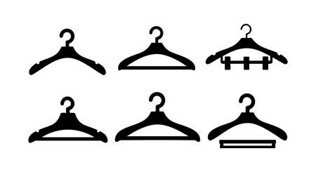 This vector illustration shows six black coat hangers in different styles used for organizing clothes in a closet or wardrobe. The design is simple and clear. Practical and neat mood.のイラスト素材