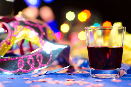 Carnival mask with a beverageの写真素材