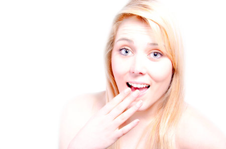 Beautiful young woman looking surprised at youの写真素材