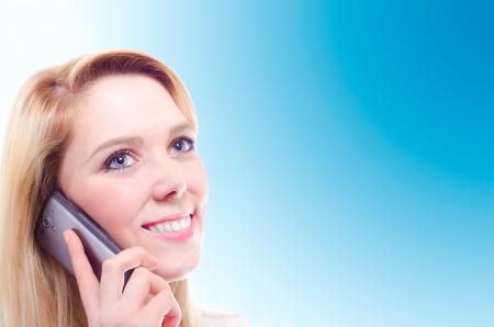 A beautiful young blonde woman making a phone call with copy spaceの写真素材