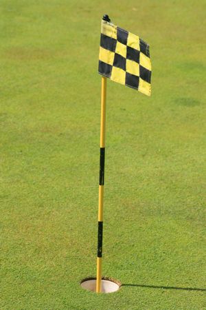 Flag on a green grass golf course.の写真素材