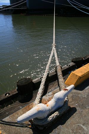 Close up of an old and rusty seaport anchor.