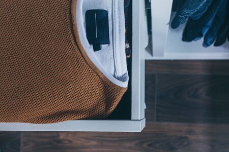 sweater in a drawer and pants hanger, open wardrobe