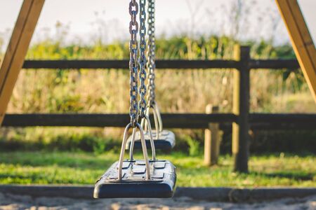 swings isolated in the parkの写真素材