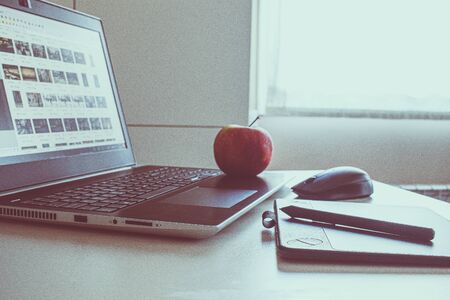 tablet drawing in workspace with laptop