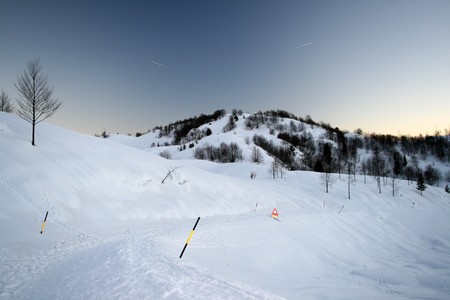 panoramic snowy view of a mountain landscape in winterの写真素材