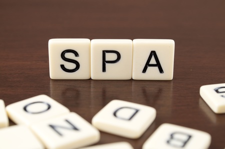 SPA spelled from letter tiles on a wooden backgroundの写真素材