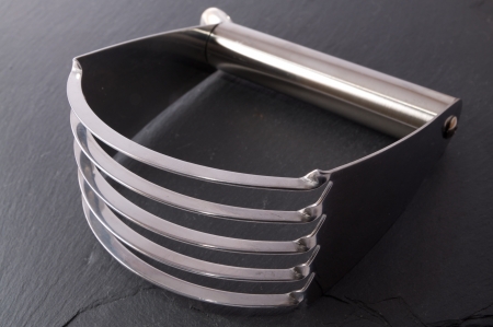 Stainless steel pastry blender on a slate backgroundの写真素材