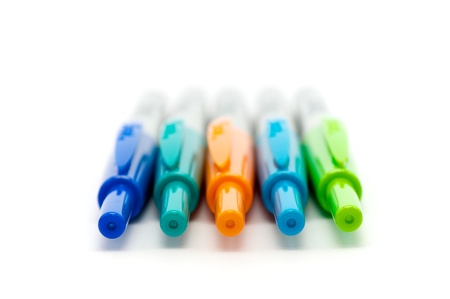 Colorful markers lines up on a white backgroundの写真素材