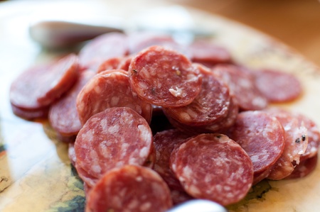 Salami sliced up and served on a Tuscan platterの写真素材