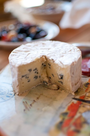 Small wheel of bliue brie on a tuscan cutting boardの写真素材