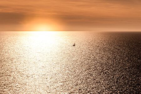sunset with a small sailboat