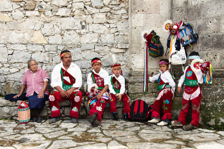 CUETZALAN, MEXICO - 2012: A family of acrobats known as "los voladores" prepare to perform in the Cuetzalan zocalo, while standing in front of Parroquia de San Francisco de AsÃ­s.のeditorial素材