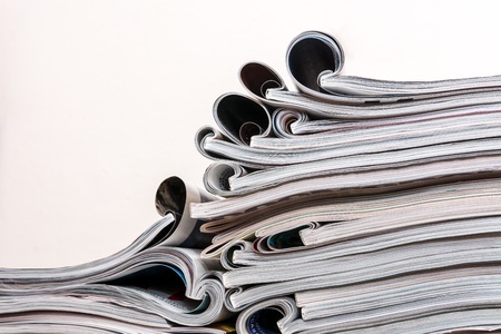 Several magazines opened and then stacked in forming stacks of paper with curlsの写真素材