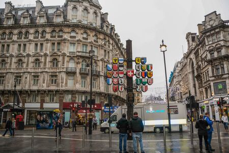 London, Greater London / England - December 13, 2016: Leicester Square view at Christmas time, with the cantonal Swiss shields and a police vanのeditorial素材