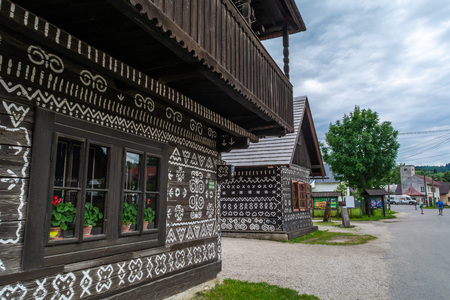 Cicmany, Zilina / Slovakia - June 16, 2018:  Traditional houses with geometric white paintings as a decoration, in a mountain village.のeditorial素材